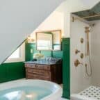 spacious bathroom with large soaking tub, dressing vanity, and jetted walk-in shower