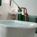 Two person soaking tub with double sinks in a grand bathroom