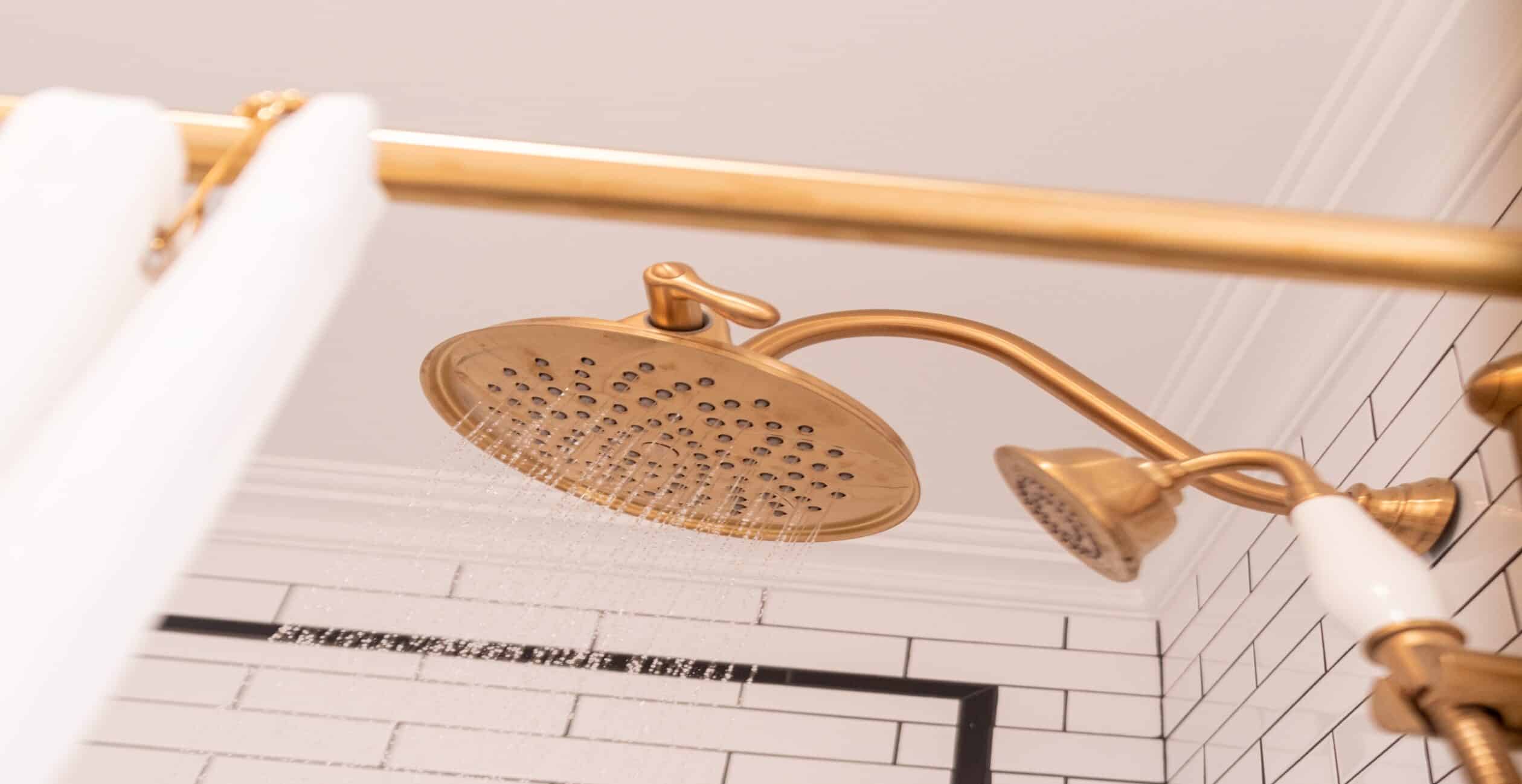 Gold shower fixtures with white subway tiles