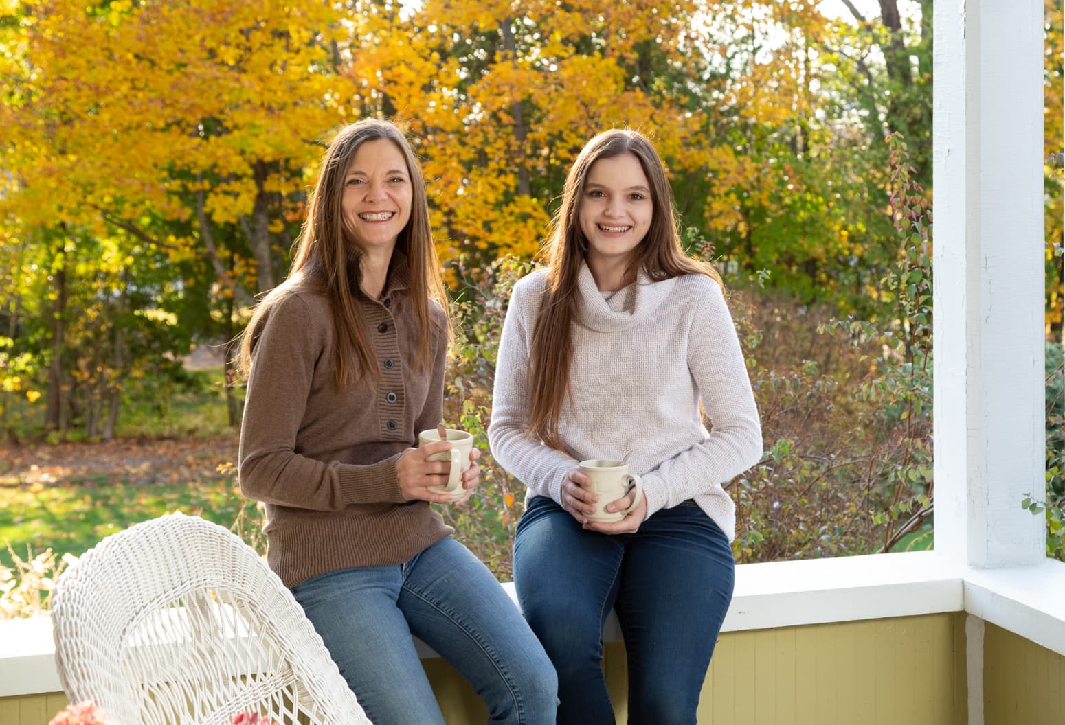 Dawn and Cassidy sitting on the front porch at Captain Nickels Inn
