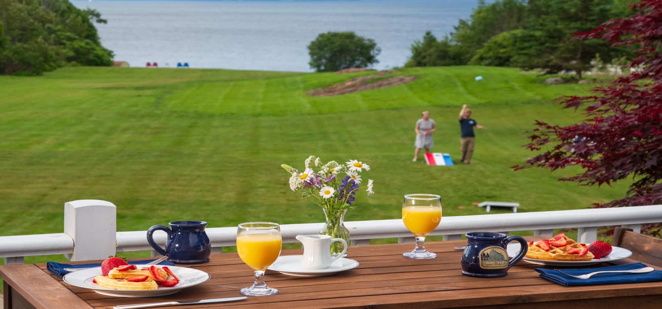 breakfast served with water views as guests play cornhole