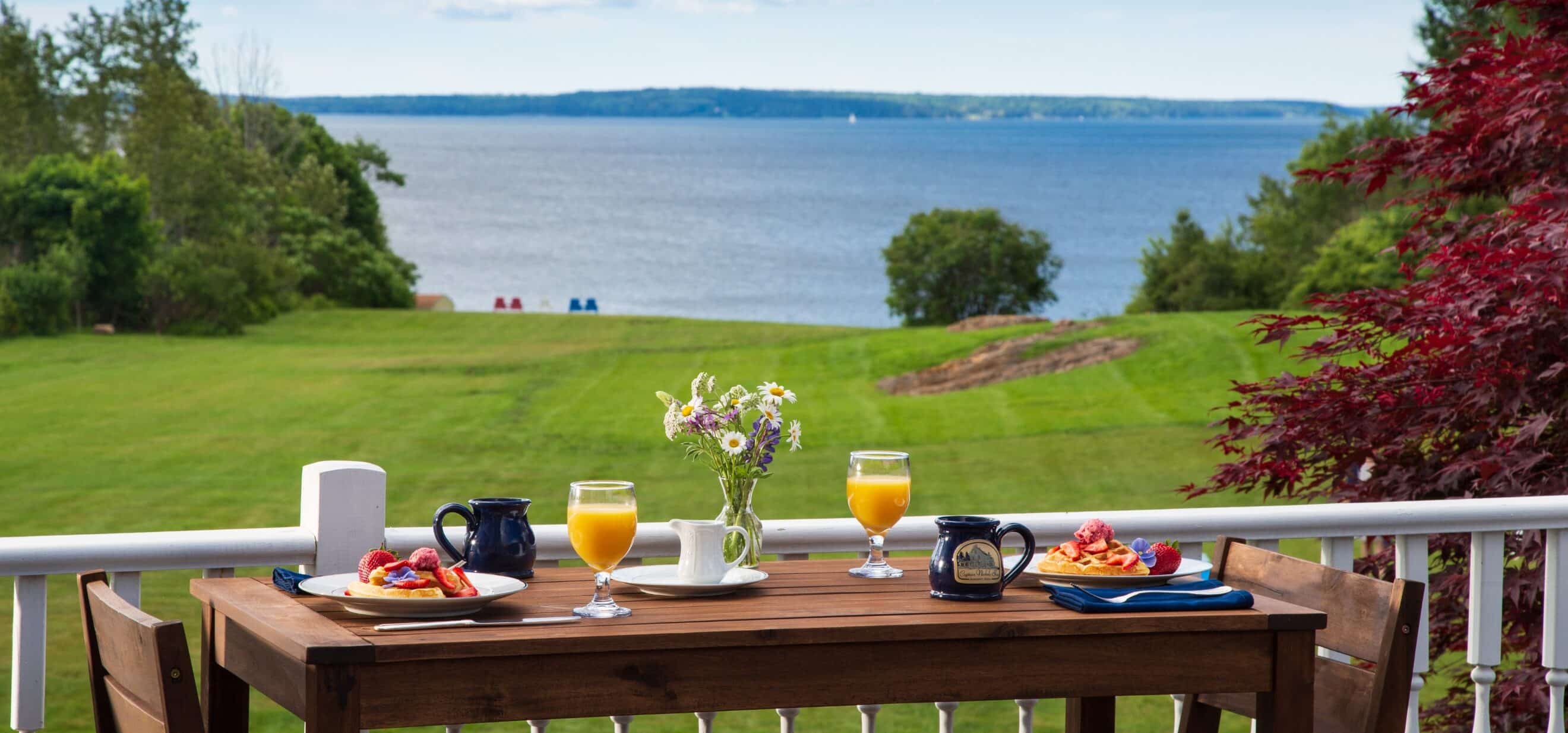 Spring breakfast set with views of the water and lawn