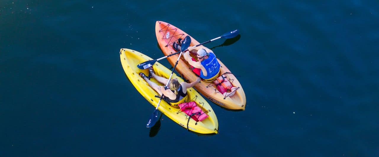 view from above: a couple kayaking out in the open water